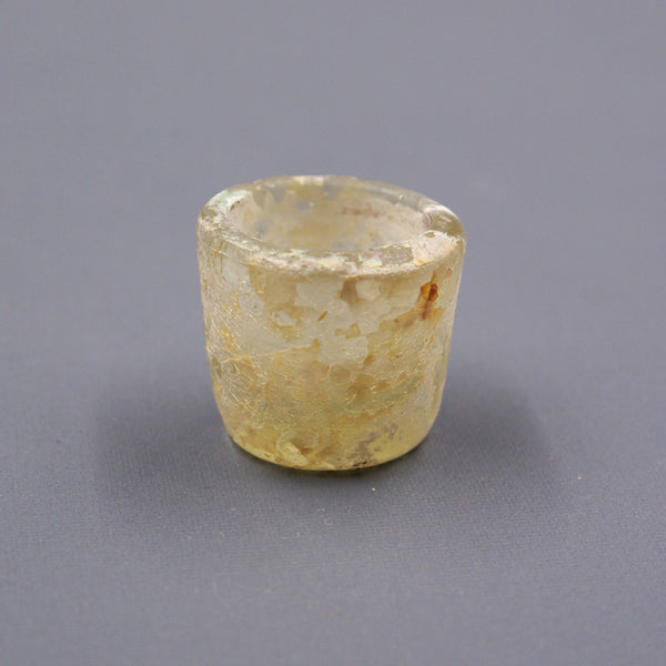 Miniature eyeshadow pot.