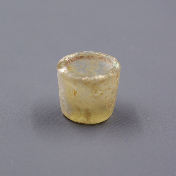 Miniature eyeshadow pot.